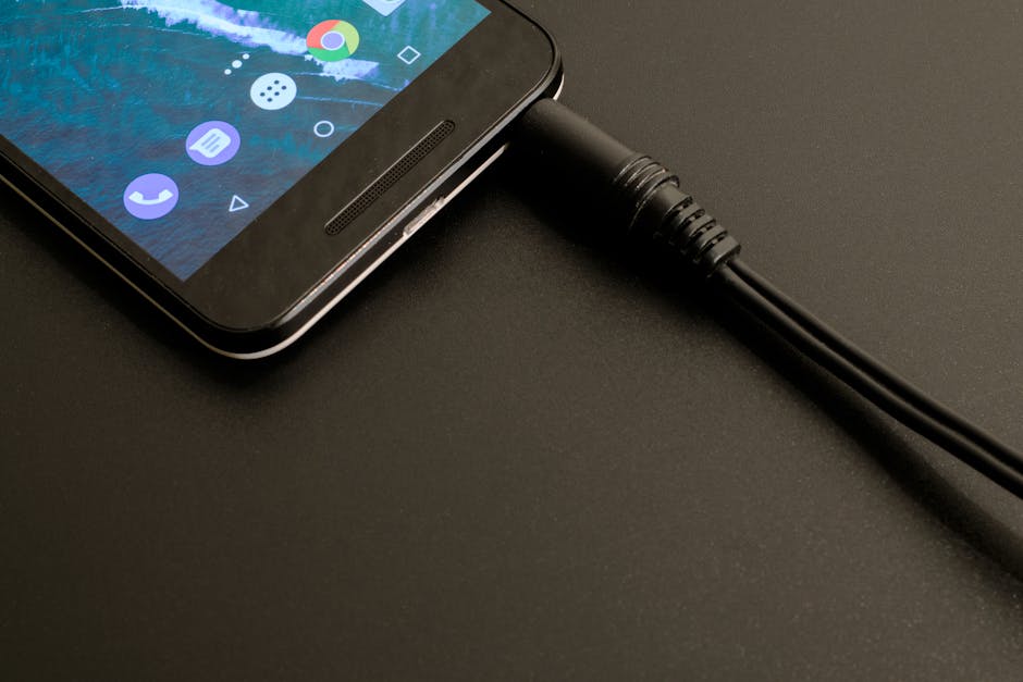 Close-up of a smartphone being charged, displaying a modern interface on a dark backdrop.